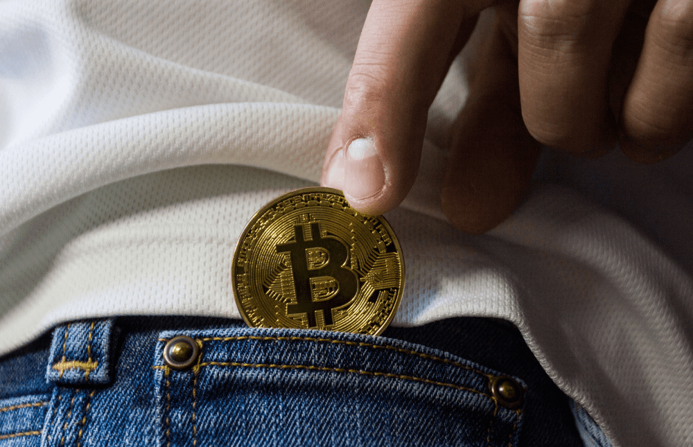 Bitcoin coin in a jeans pocket